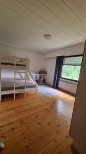 a bedroom with a bunk bed and a wooden floor at Happy place in Kitee