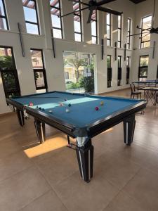 a pool table in the middle of a room at Villa Ecotiva Mahabalipuram in Chennai