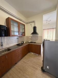a kitchen with a sink and a refrigerator at Villa Ecotiva Mahabalipuram in Chennai