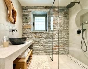 a bathroom with a sink and a glass shower at Agnandio Retreat Euboea in Animborió +95 photos