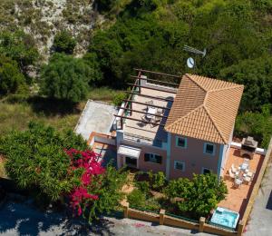 an aerial view of a house with a roof at Villa Verde with Outdoor Jacuzzi in Divarata