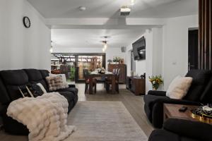 a living room with a couch and a table at Drago Chalet Sinaia, hot tub and sauna in Sinaia