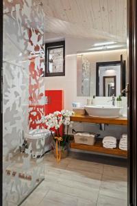 a bathroom with a sink and a mirror at Drago Chalet Sinaia, hot tub and sauna in Sinaia +36 photos