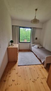 a bedroom with a bed and a window at Happy place in Kitee +8 photos