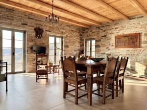 a dining room with a wooden table and chairs at Agnandio Retreat Euboea in Animborió