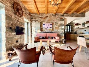 a living room with a couch and a table and chairs at Agnandio Retreat Euboea in Animborió