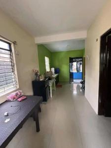 a living room with a bench and green walls at Familia homes in Lipa