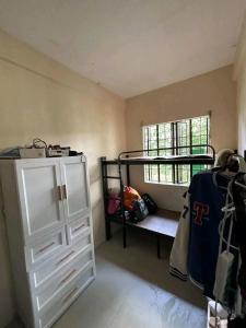 a bedroom with a bunk bed and a bunk room with a closet at Familia homes in Lipa