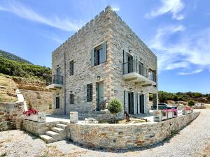 a stone house with a stone wall at Agnandio Retreat Euboea in Animborió