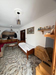 a living room with a bed and a couch at Stone House in Vlorë