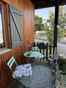 a patio with two chairs and a table on a porch at Le Chalet Hubertus - Climatisé - 80 m2 in Rohrbach-lès-Bitche