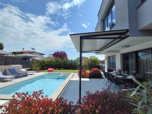 a house with a swimming pool in a yard at Villa Calypso, private pool with heating and salt water in Lozenets