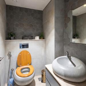 a bathroom with a toilet and a sink at Sifa Golf Lake in Muscat
