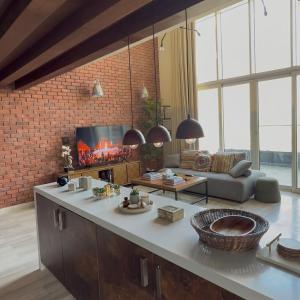 a living room with a couch and a fireplace at Sifa Golf Lake in Muscat +3 photos