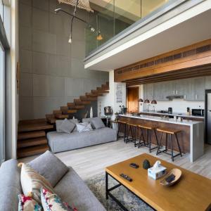 a living room with a couch and a table at Sifa Golf Lake in Muscat