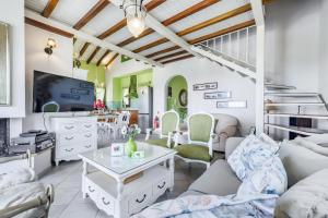 a living room with a couch and a tv at Luxury Villa with Private Pool in Skopelos, Spacious & Private, Villa Amaryllis By Kardous in Alikias