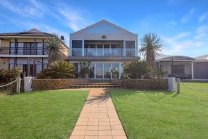 a large house with a lawn in front of it at Lakeside Serenity in Hindmarsh Island