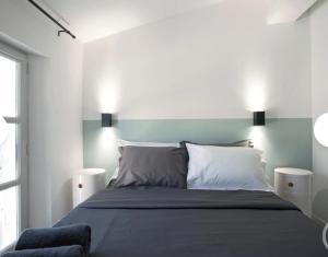 a bedroom with a large bed with two pillows at Cocon Voltaire - Arles centre historique in Arles