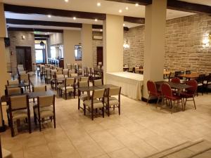 a dining room with tables and chairs and brick walls at Hotel Rivoli in Mar del Plata