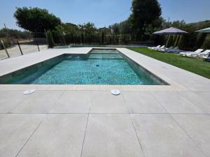 a swimming pool in a yard with chairs at Moratalla Buenos Deseos - Oasis Natural 2 in Moratalla