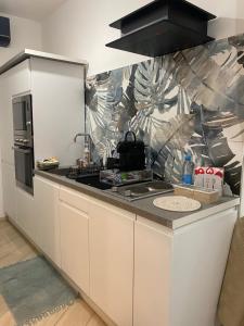 a kitchen with a sink and a counter top at Casa Acquarello in Savona