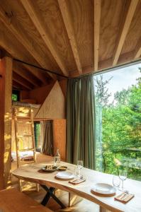 a dining room with a table and a large window at Hutstuf La Roche-en-Ardenne in La-Roche-en-Ardenne +46 photos