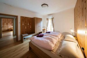 a bedroom with a large bed in a room at Hiša Tam Čez in Slovenj Gradec