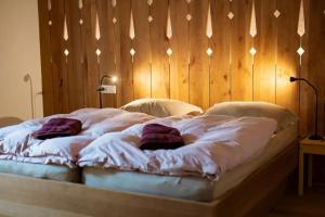 a bed with two pillows on it in a bedroom at Hiša Tam Čez in Slovenj Gradec