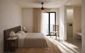 a bedroom with a bed and a ceiling fan at Anoi Kefalonia in Argostoli