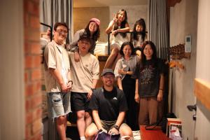 a group of people posing for a picture in a room at 私藏52 九份金瓜石民宿 旅宿攝影 in Ruifang