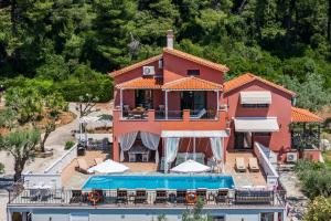 a villa with a swimming pool and a house at Luxury Villa with Private Pool in Skopelos, Spacious & Private, Villa Amaryllis By Kardous in Alikias