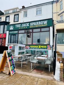 a restaurant with tables and chairs in front of it at The Jack Sparrow Hotel in Blackpool