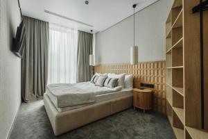 a bedroom with a bed and a large window at Fomich Estates in Bukovel