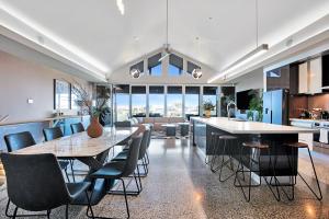 a kitchen and dining room with a table and chairs at Lakeside Serenity in Hindmarsh Island