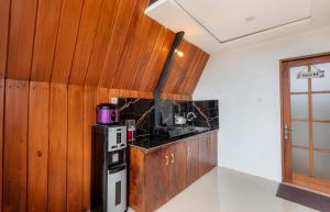 a kitchen with wooden walls and a stove top oven at Villa Platinum 2 in Banjarnegara +14 photos