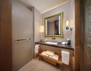 a bathroom with a sink and a mirror at Bristoria Hotel Yangzhou in Yangzhou +56 photos