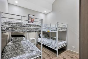 a bedroom with two bunk beds and a bed at Lakeside Serenity in Hindmarsh Island +28 photos
