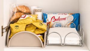 a shelf in a refrigerator filled with food and bread at Maison Alexeur - Intero Appartamento in Crotone +9 photos