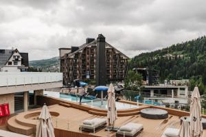 a resort with a pool and a building at Fomich Estates in Bukovel