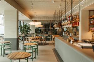 a restaurant with wooden tables and green chairs at Fomich Estates in Bukovel