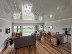 a living room with a couch and a table at Princess Vlei Lodge in Grassy Park