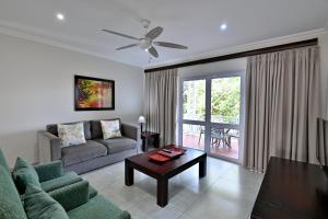 a living room with a couch and a table at Caribbean Estates by MyResorts in Port Edward