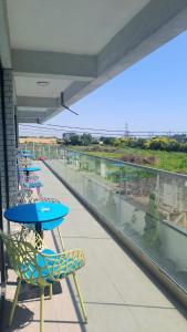 a balcony with tables and chairs and a view of the ocean at Vila Arthur in Eforie Nord