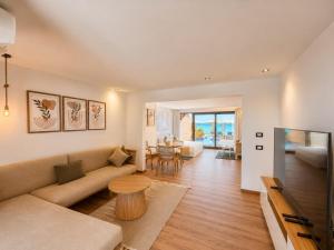 a living room with a couch and a table at XU Sidi Abdel Rahman Resort & Spa in El Alamein