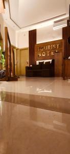 a hotel lobby with a couch and a hotel sign at swiss hotel cairo downtown in Cairo
