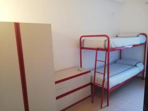 a room with two bunk beds and a mirror at Da Riccardo in Malfa