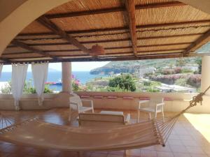 a hammock in a room with a view of the ocean at Da Riccardo in Malfa