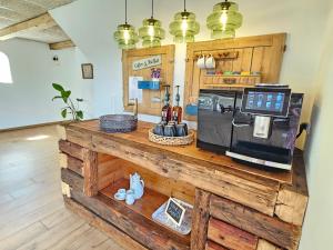 a counter with a microwave on top of it at Villa Vendel B&B in Løkken