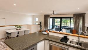 a kitchen and living room with a table and chairs at Saltwater Stay in Bunbury