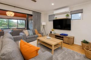 a living room with a couch and a tv at Saltwater Stay in Bunbury